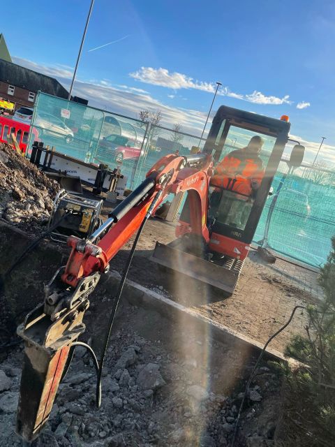 Mini excavator carrying out external groundwork excavation at a commercial site in Arbroath