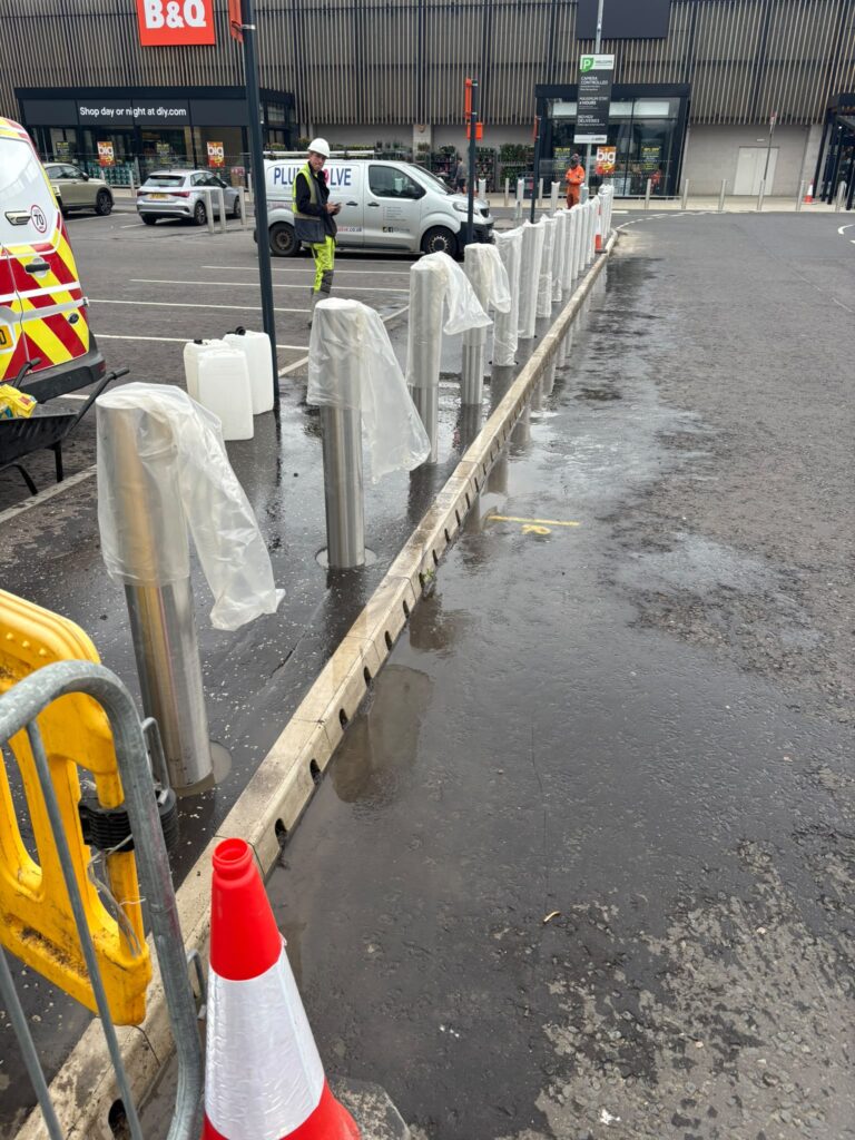 New stainless-steel bollards installed along a retail car park in Bishopbrig